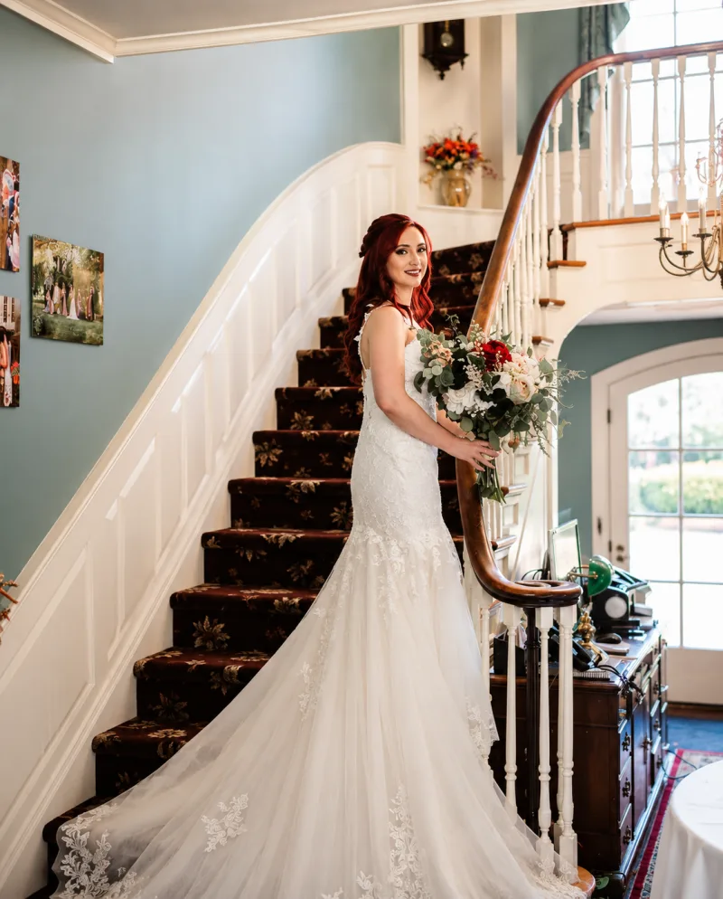 A bride on the grand staircase at the Montague Inn
