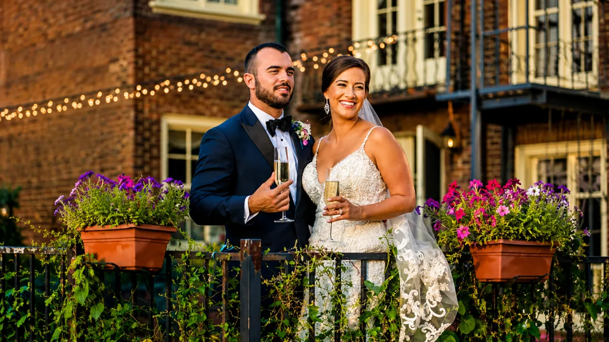 Newlyweds toast on the terrace at golden hour