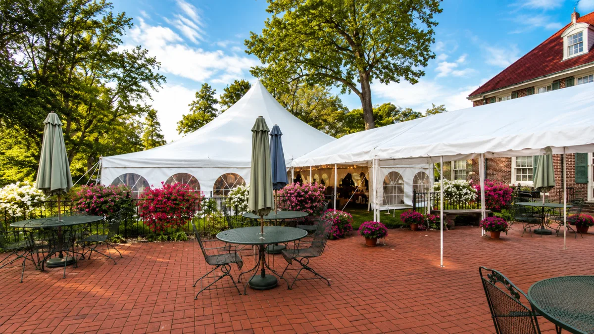 A tented reception on the brick patio